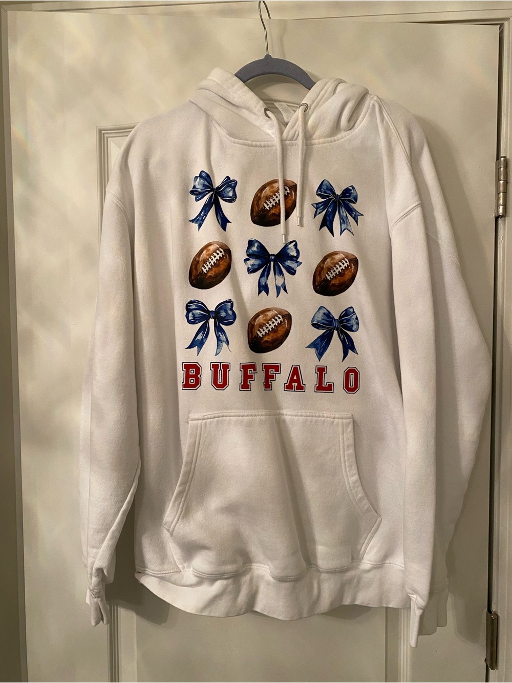 White Hoodie with Blue Bows and Football Graphic